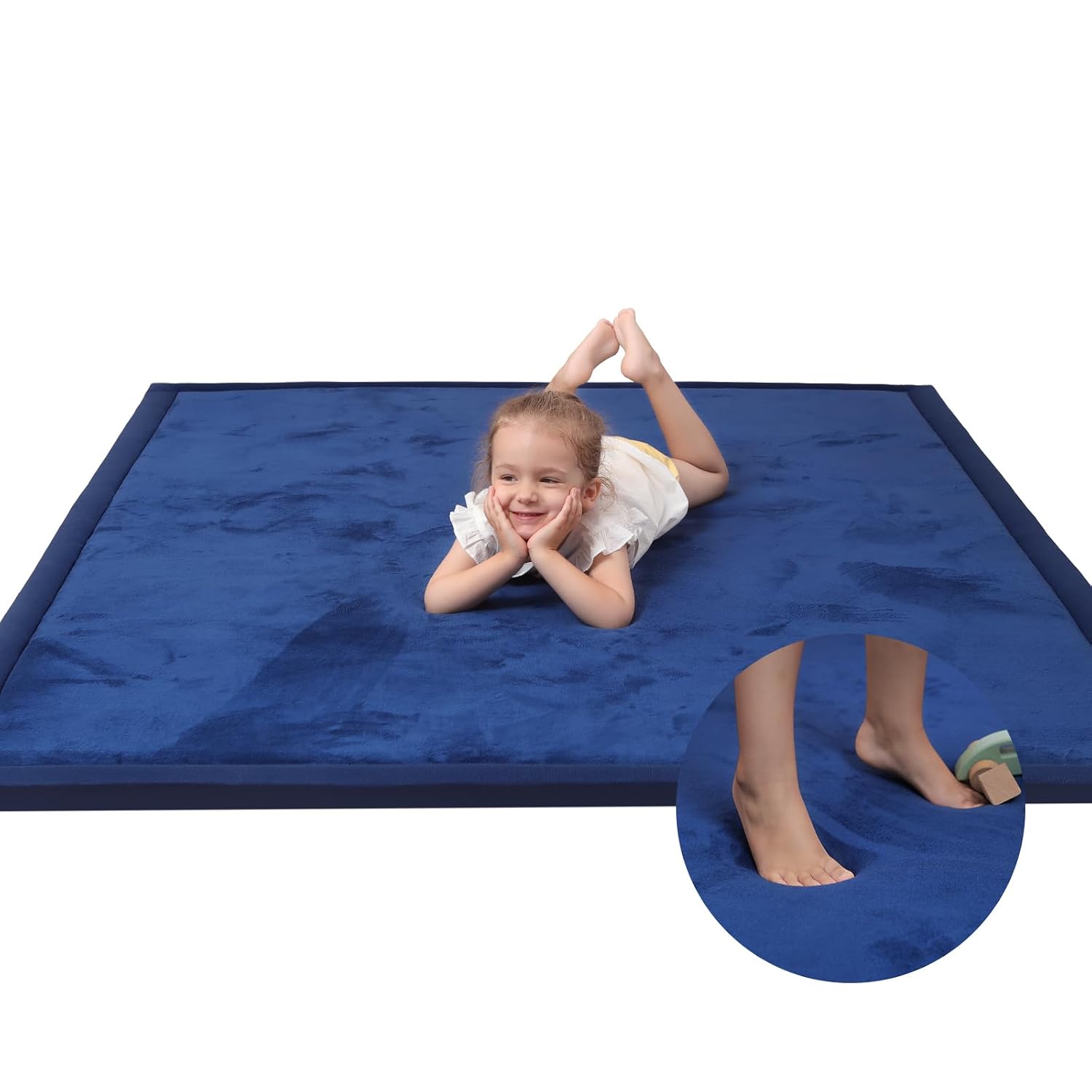 Macro close-up of royal blue velvet fabric on the baby play mat showing soft texture detail