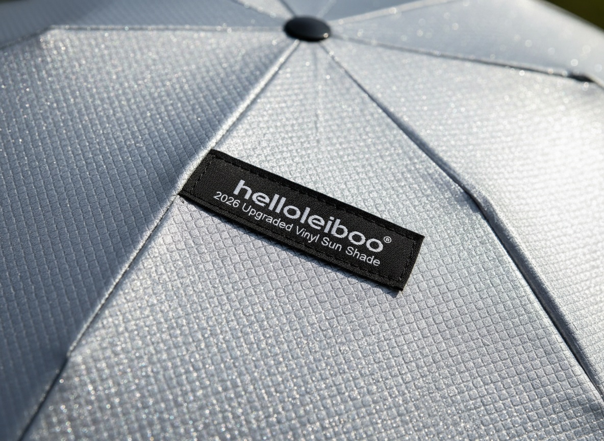 Macro close-up of sun shade's reflective 5-layer vinyl coating with silvery texture and light reflection